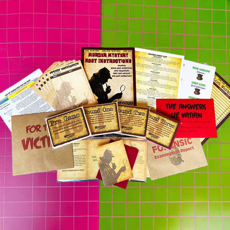 A flat-lay of a forensic mystery game set on a split pink and green grid background. The set includes instruction cards, game boards, a 'For a Victim' card, evidence boxes, and a red card that reads 'THE ANSWERS LIE WITHIN'.