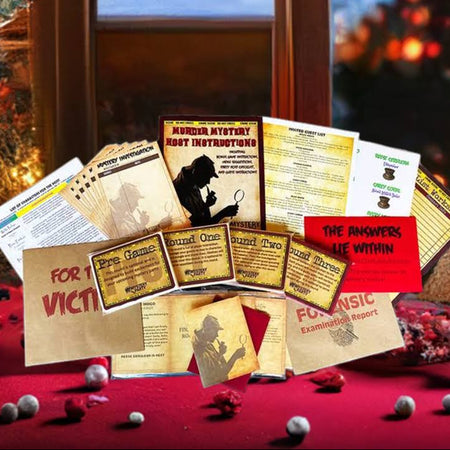 A Christmas-themed mystery game kit displayed on a red tablecloth in front of a window and decorated Christmas tree. The kit includes printed cards, instruction sheets, and a red card titled 'THE ANSWERS ARE WITHIN'.