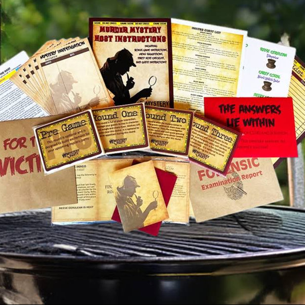 A bundle of mystery script or booklets fanned out on top of a black grill outdoors, with a blurred green garden background. The booklet covers feature vintage-style illustrations and text including 'Mystery Novel Instructions' and 'The Answers Lie Within'.