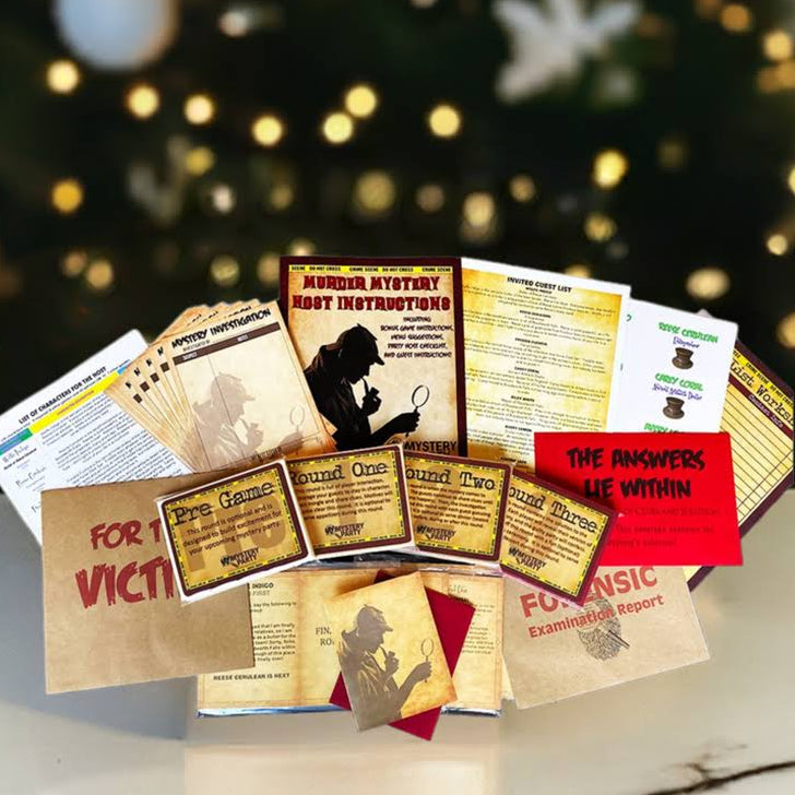 A Christmas-themed pop-up card display on a white marble tabletop, featuring various printed cards and envelopes with holiday messages, set against a blurred Christmas tree background.