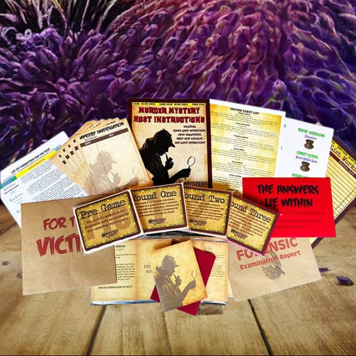 A collection of printed evidence-examination cards, worksheets, and small cards arranged on a wooden tabletop, with a dramatic fireworks display in the background. Visible text includes 'HARDLY ATTYWE ART DEPARTMENT' and 'THE ANSWERS LIE WITHIN'.